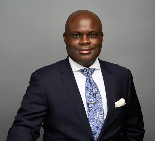 A man in a suit and tie standing.